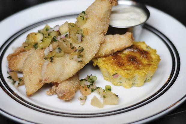 Rice fried catfish with pickled green tomatoes, jalapeño cheddar spoonbread, and malt vinegar remoulade at the Capital Bar & Grille