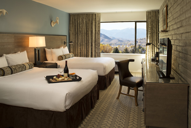 A renovated bedroom at the Snow King Resort with stunning views of the Tetons