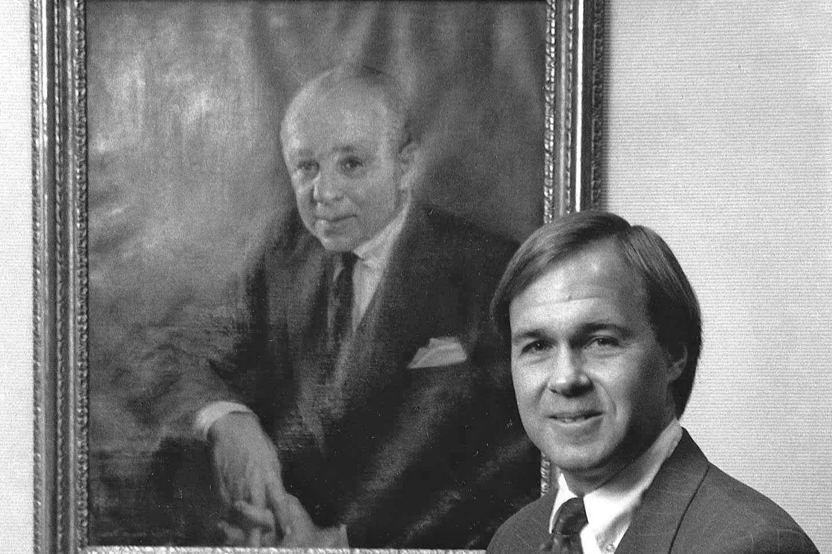 Winthrop Smith Jr. at Merrill Lynch with a portrait of his father, one of the company's co-founders